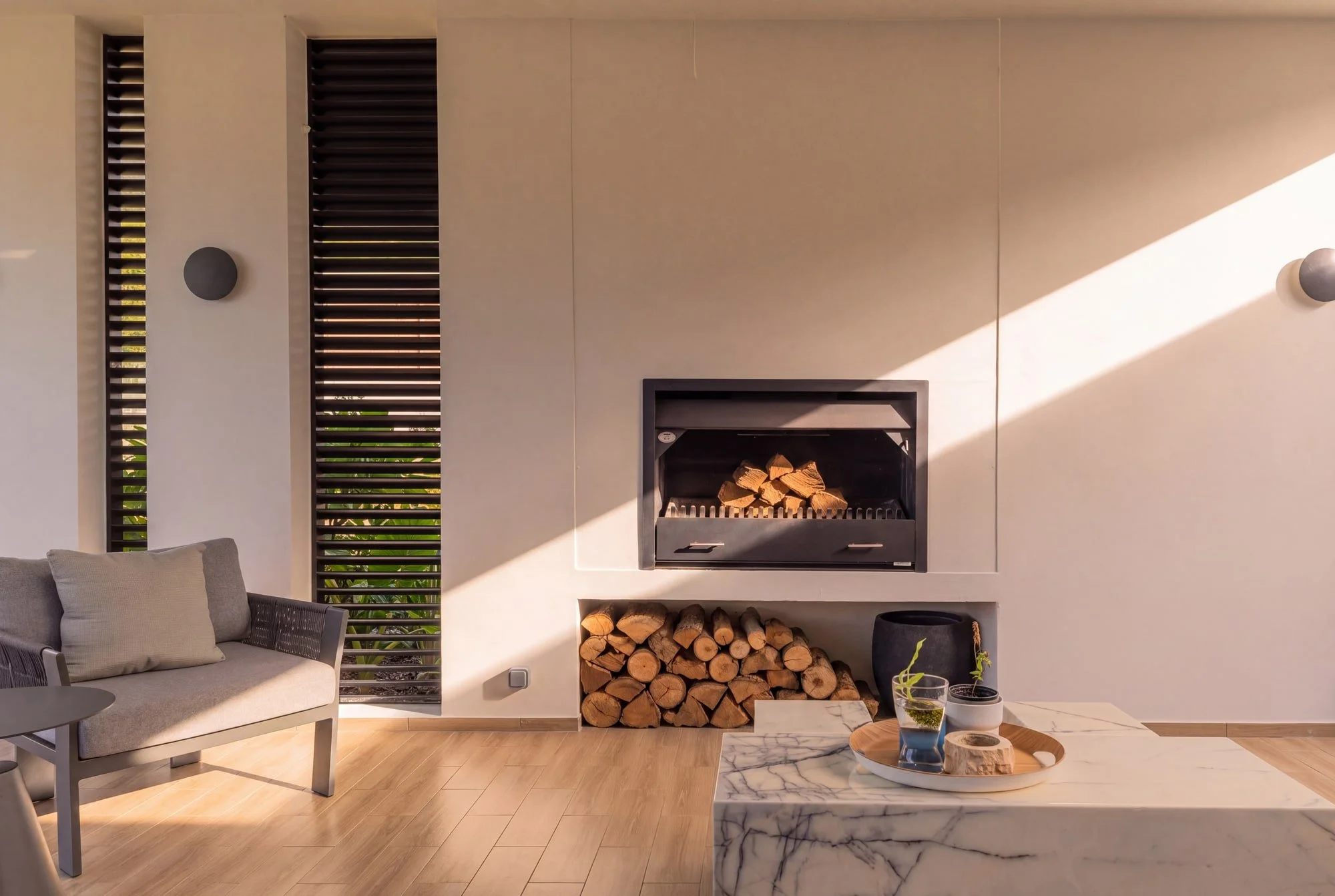 Outdoor fireplace lounge at Krono Residence