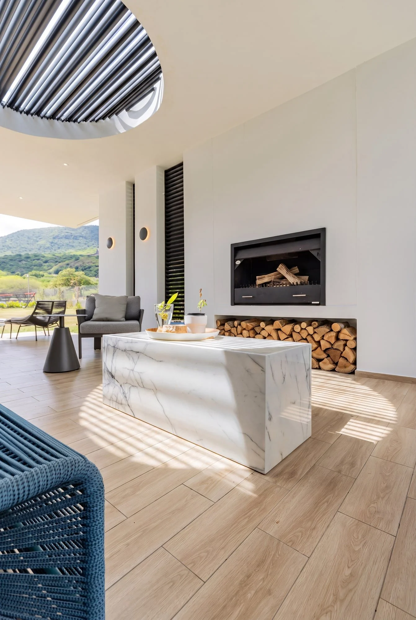 Outdoor fireplace and marble table on the covered terrace