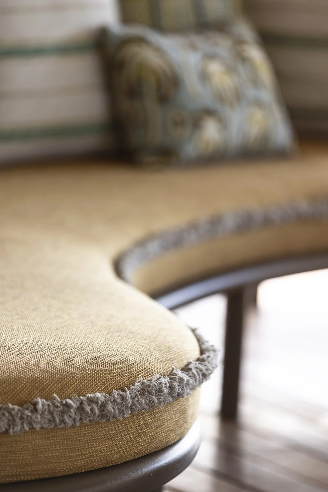 Textural upholstery and fringe detail in the outdoor lounge