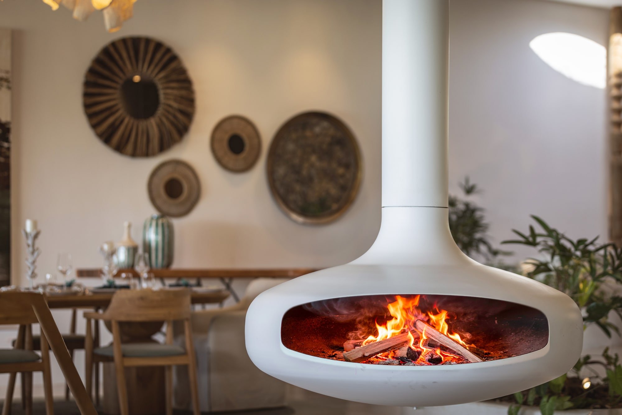 Suspended white fireplace creating a focal point in the dining area