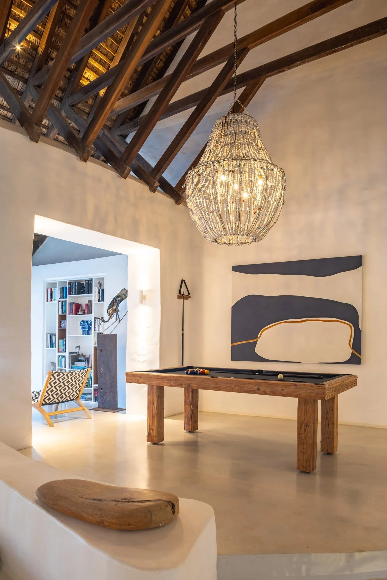 Vaulted entrance hall with exposed timber structure and contemporary art