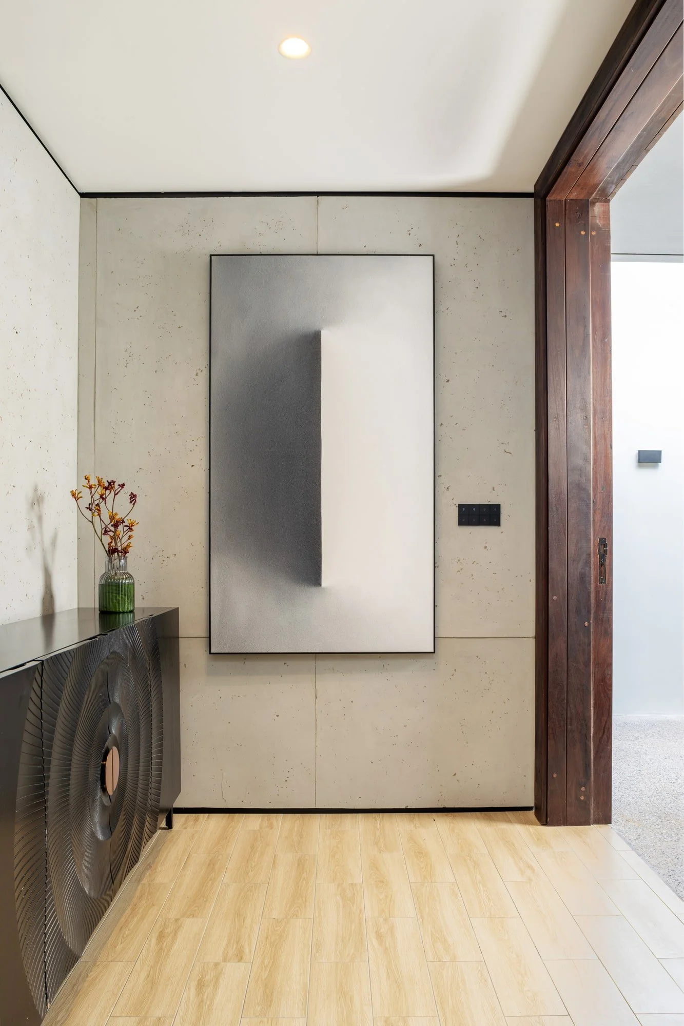 Krono Residence entry hall with artwork and sculptural console