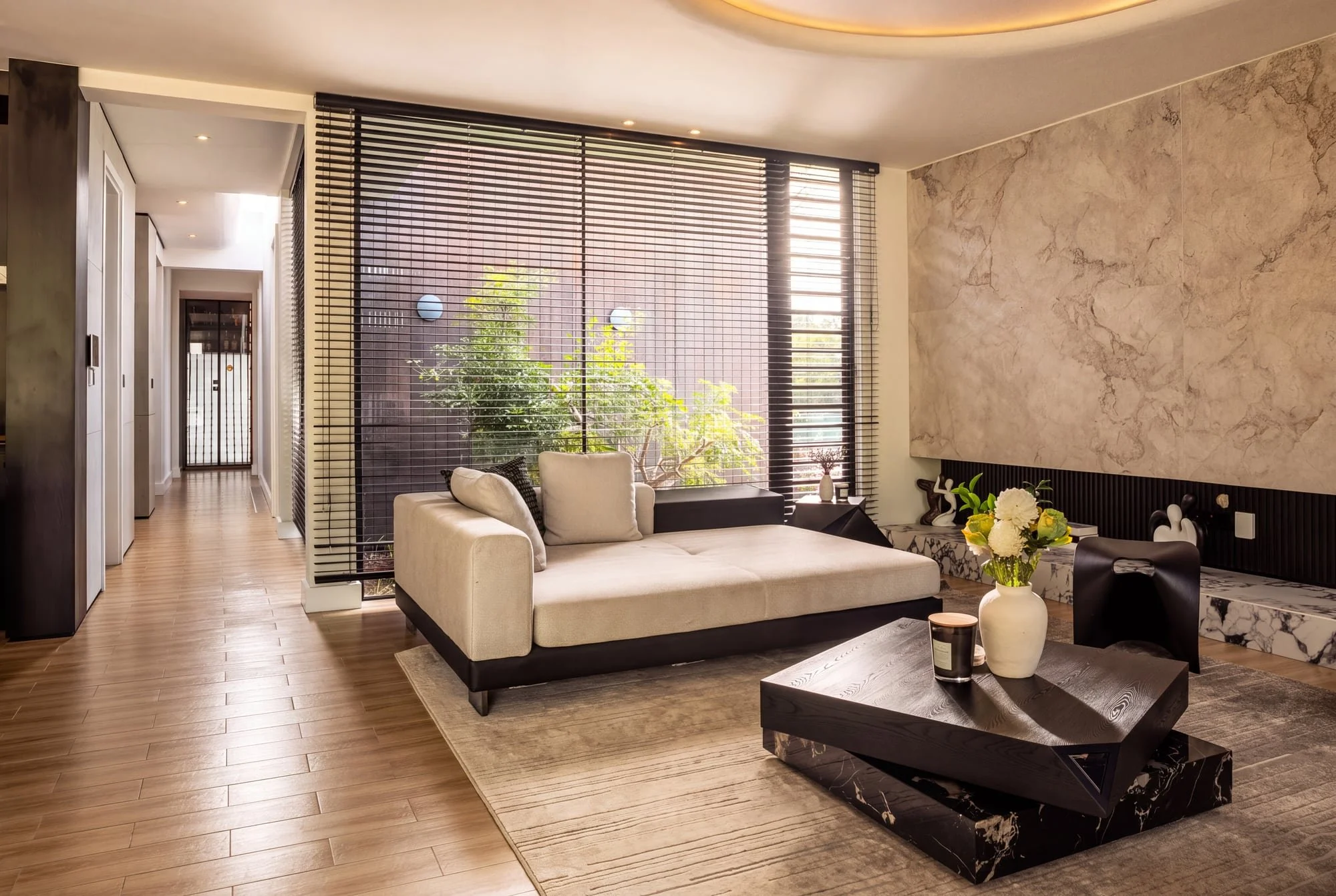 Living room with marble feature wall at Krono Residence