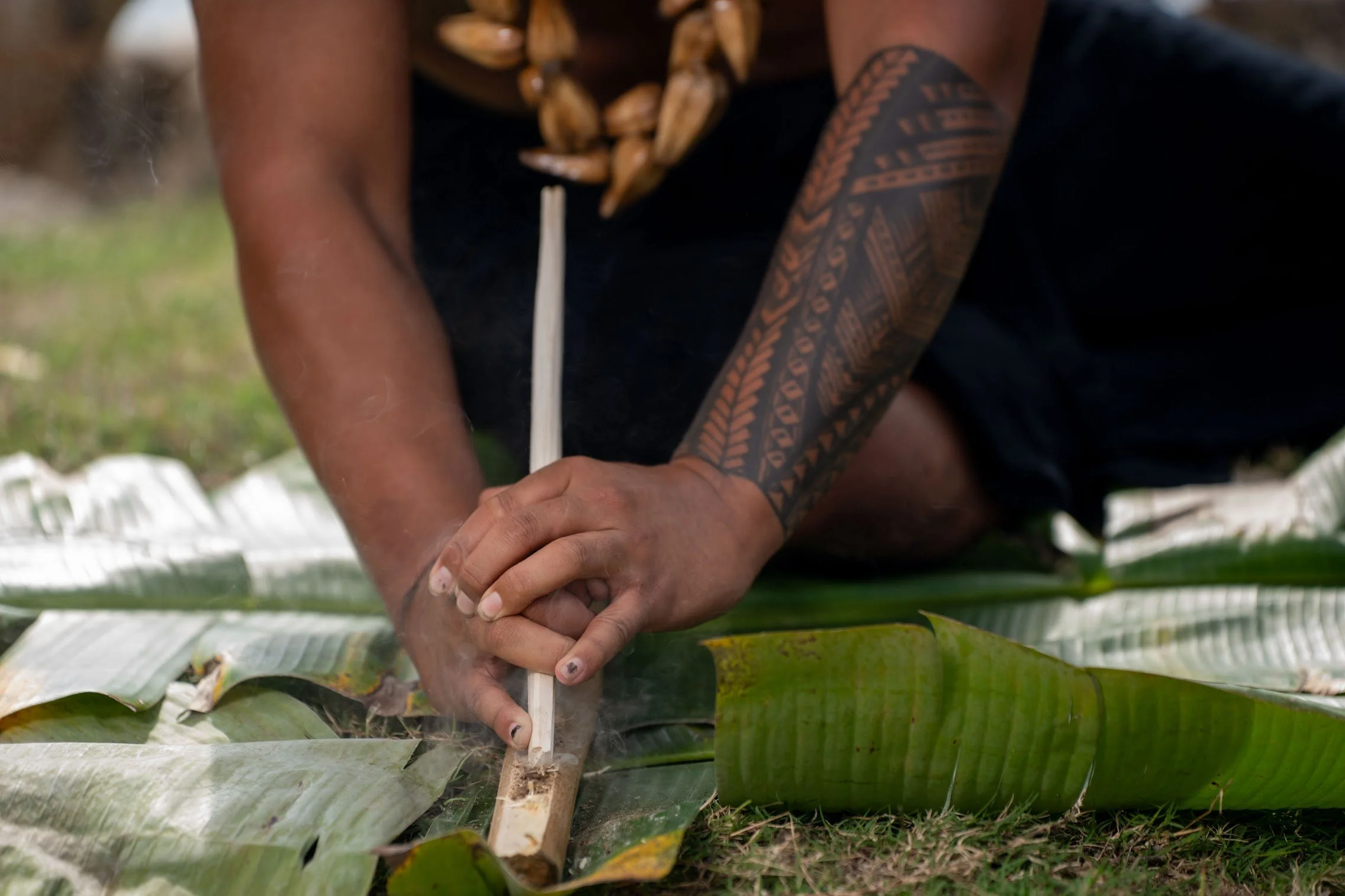 Kap's son starts a fire using natural materials and traditional methods.