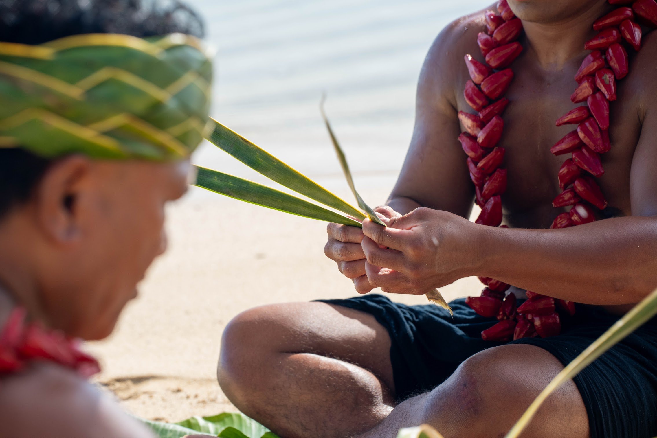 Learning how to weave leaves.