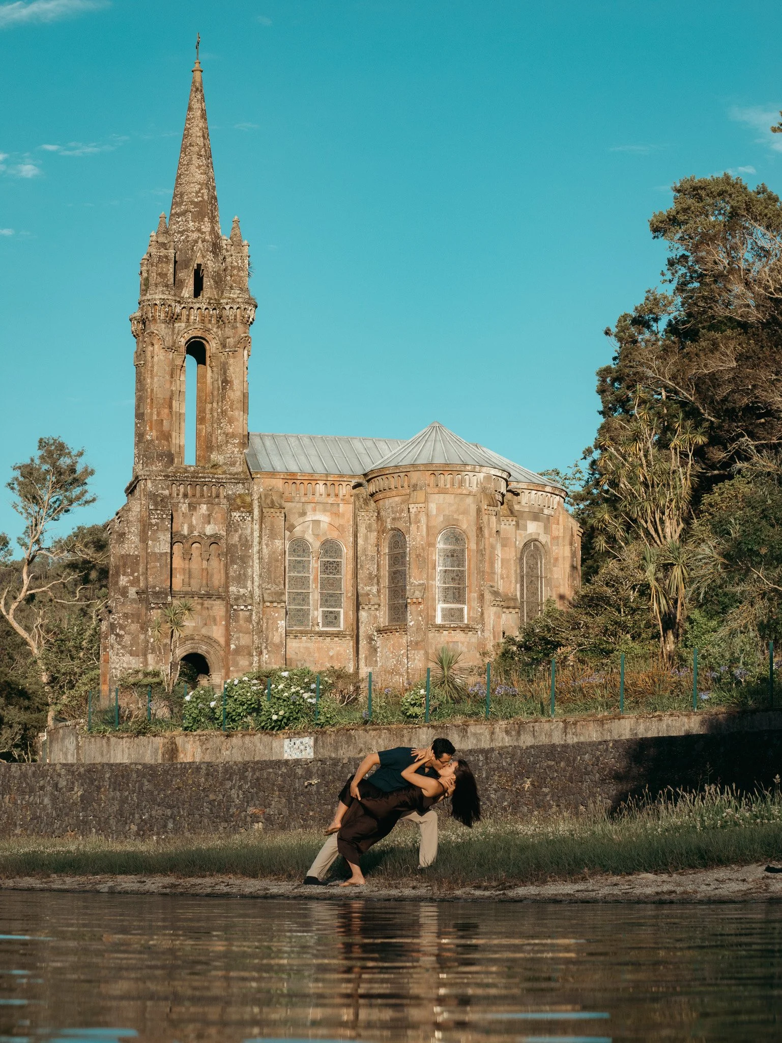 omantic couple posing for a photoshoot in the Azores at the historic Ermida das Vitórias, captured by a professional Azores wedding photographer