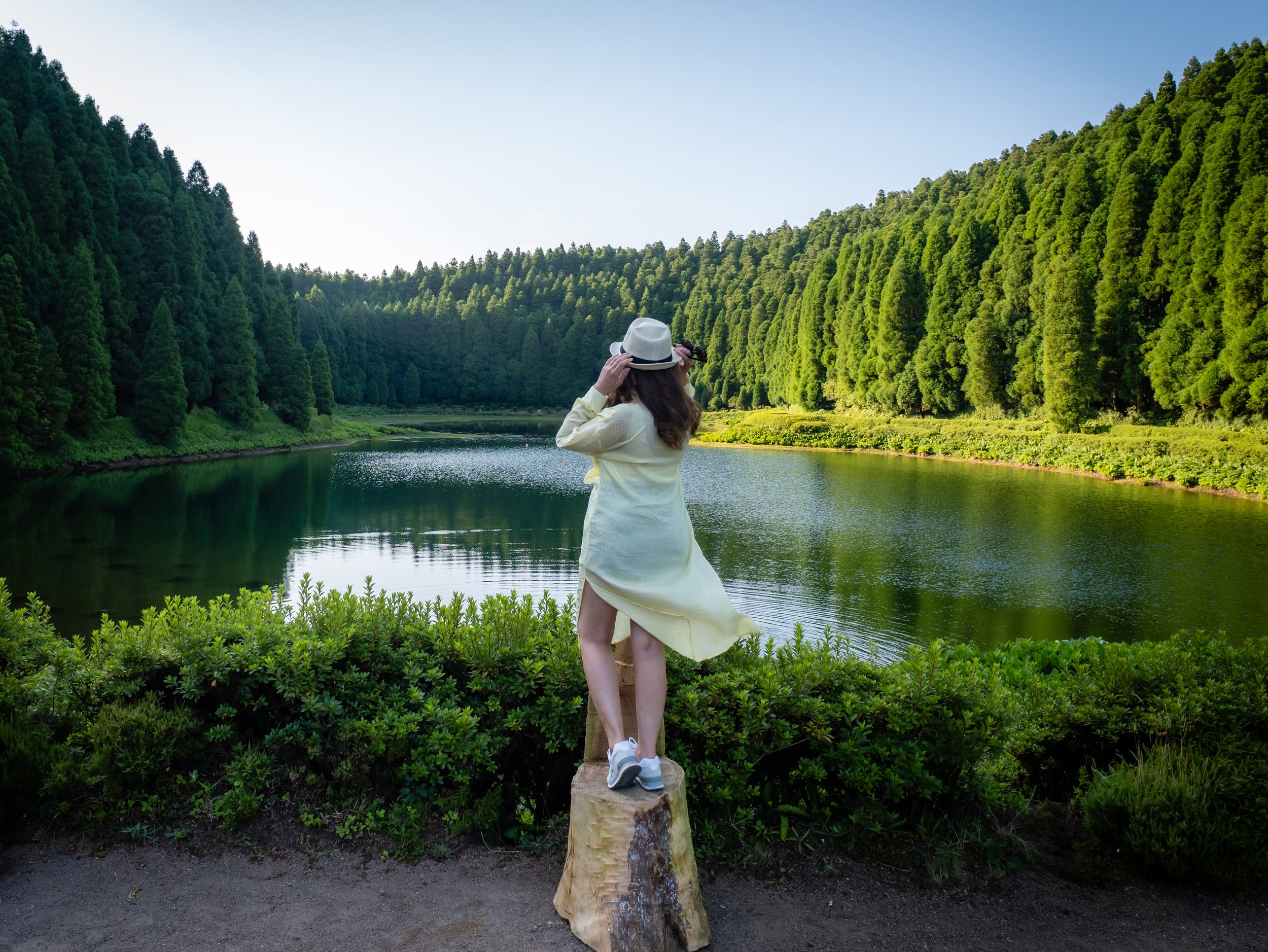 Woman enjoying a peaceful lake in São Miguel, Azores, during a vacation photo session with a local photographer