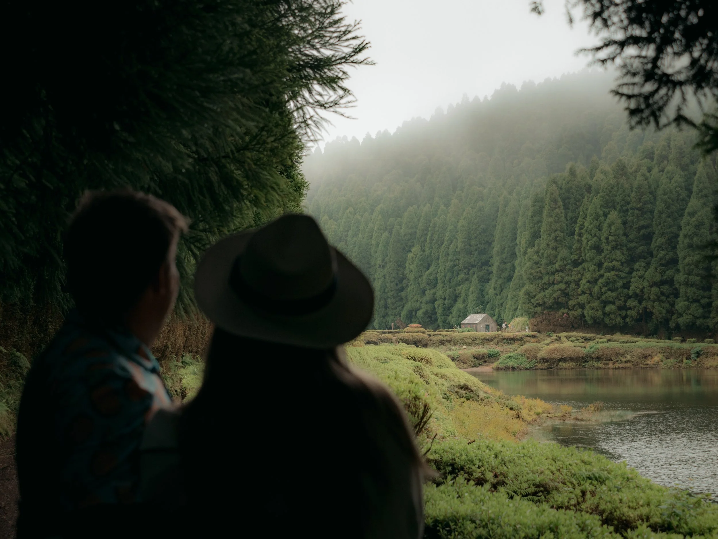 Travelers enjoying a quiet forest lake during a private tour in São Miguel, Azores