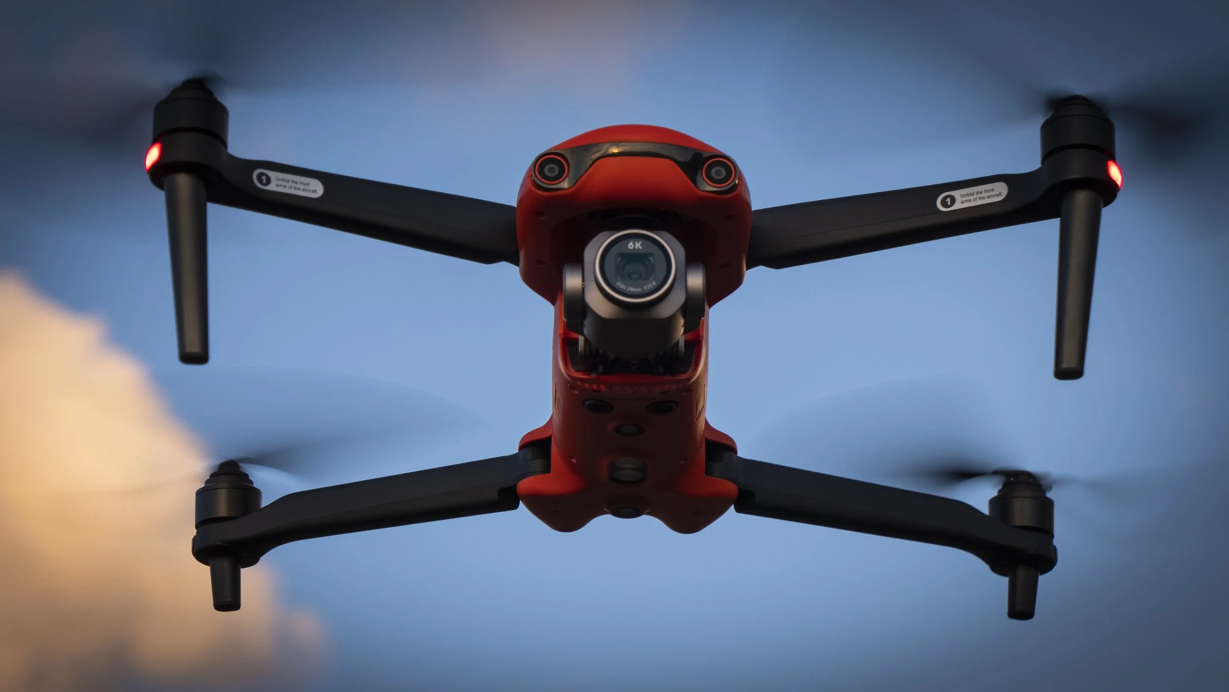 Close-up of a red 6K drone in flight during a Drone Workshop in the Azores, captured while teaching beginners cinematic moves
