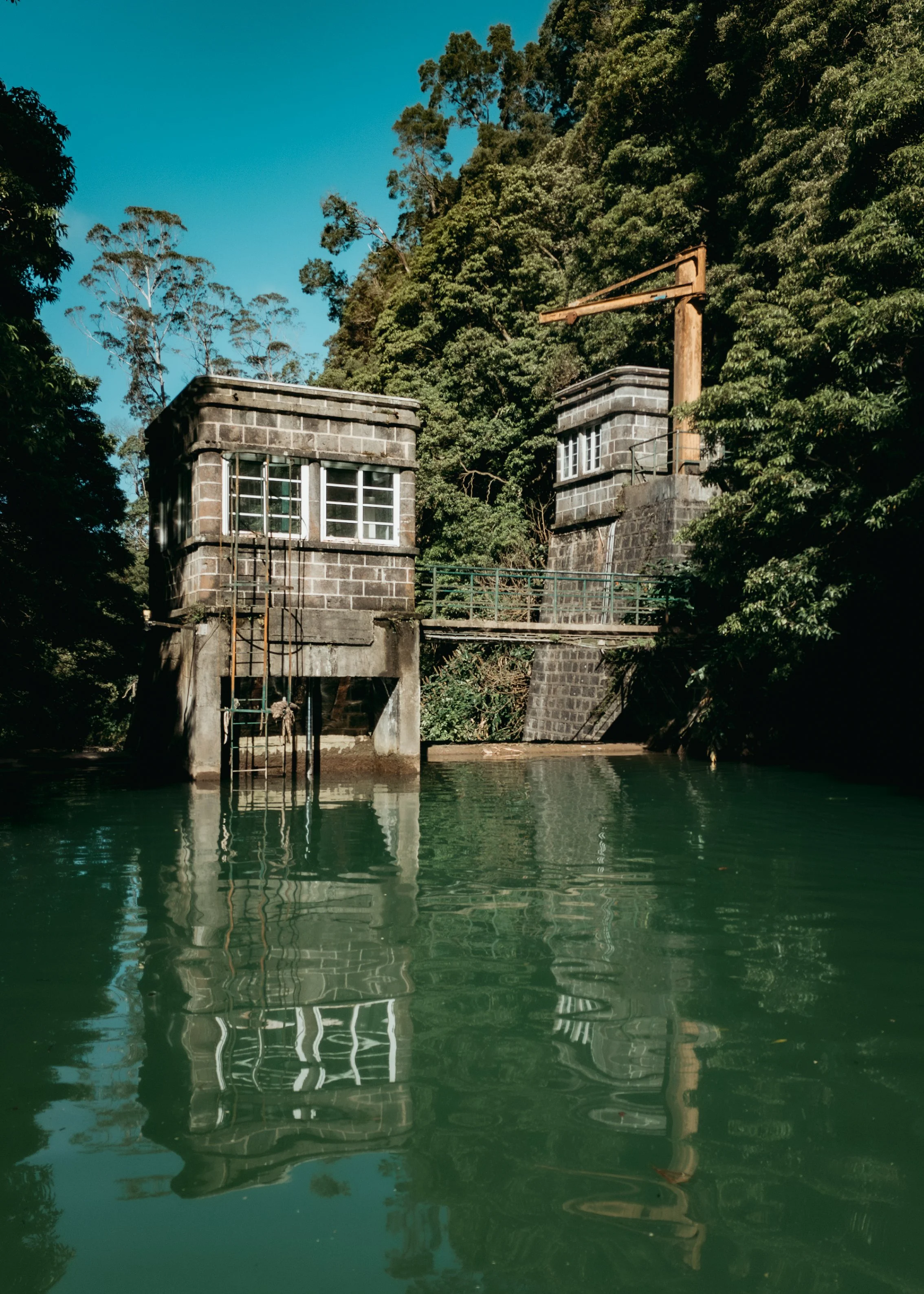Hidden gem water reservoir surrounded by forest in São Miguel Island, Azores, photographed during an Azores photo tour