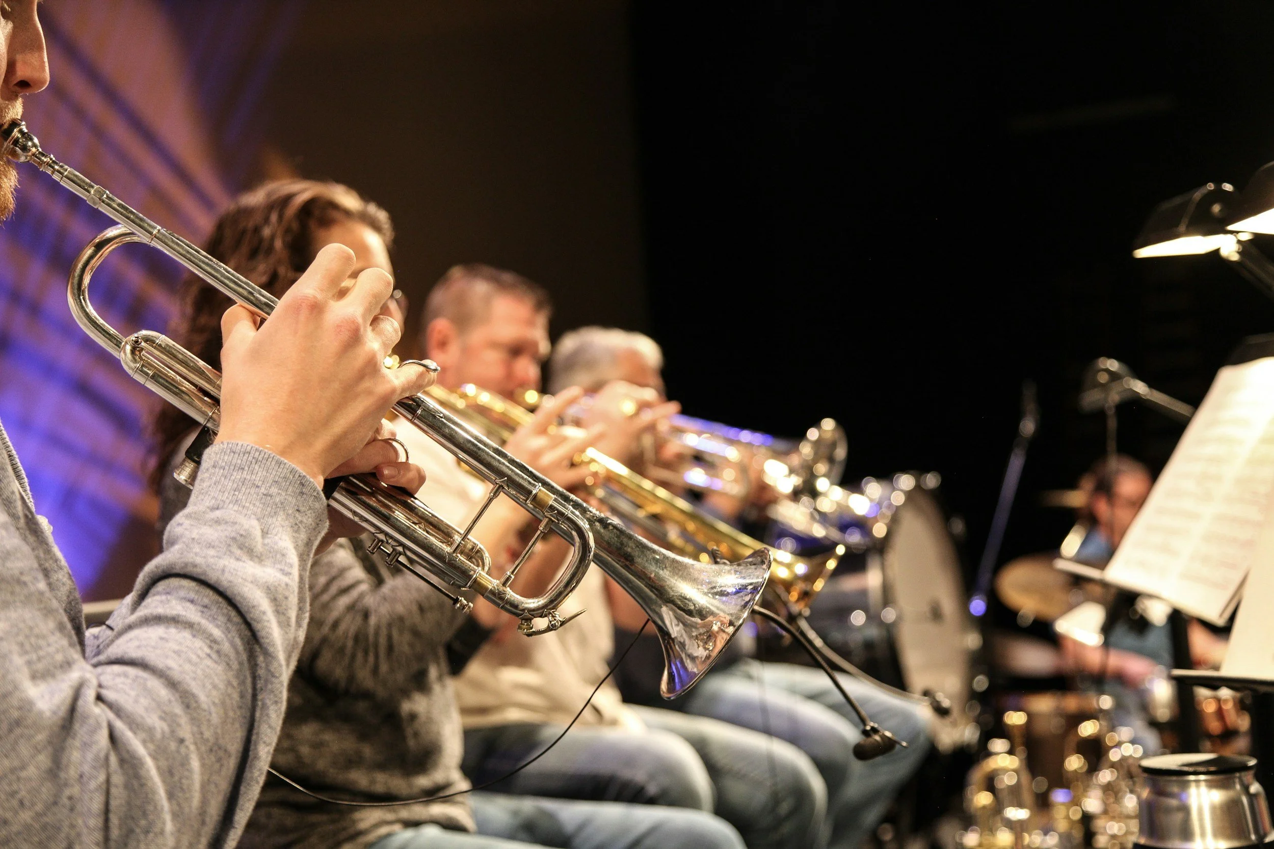 Musicians playing trumpets in an orchestra setting