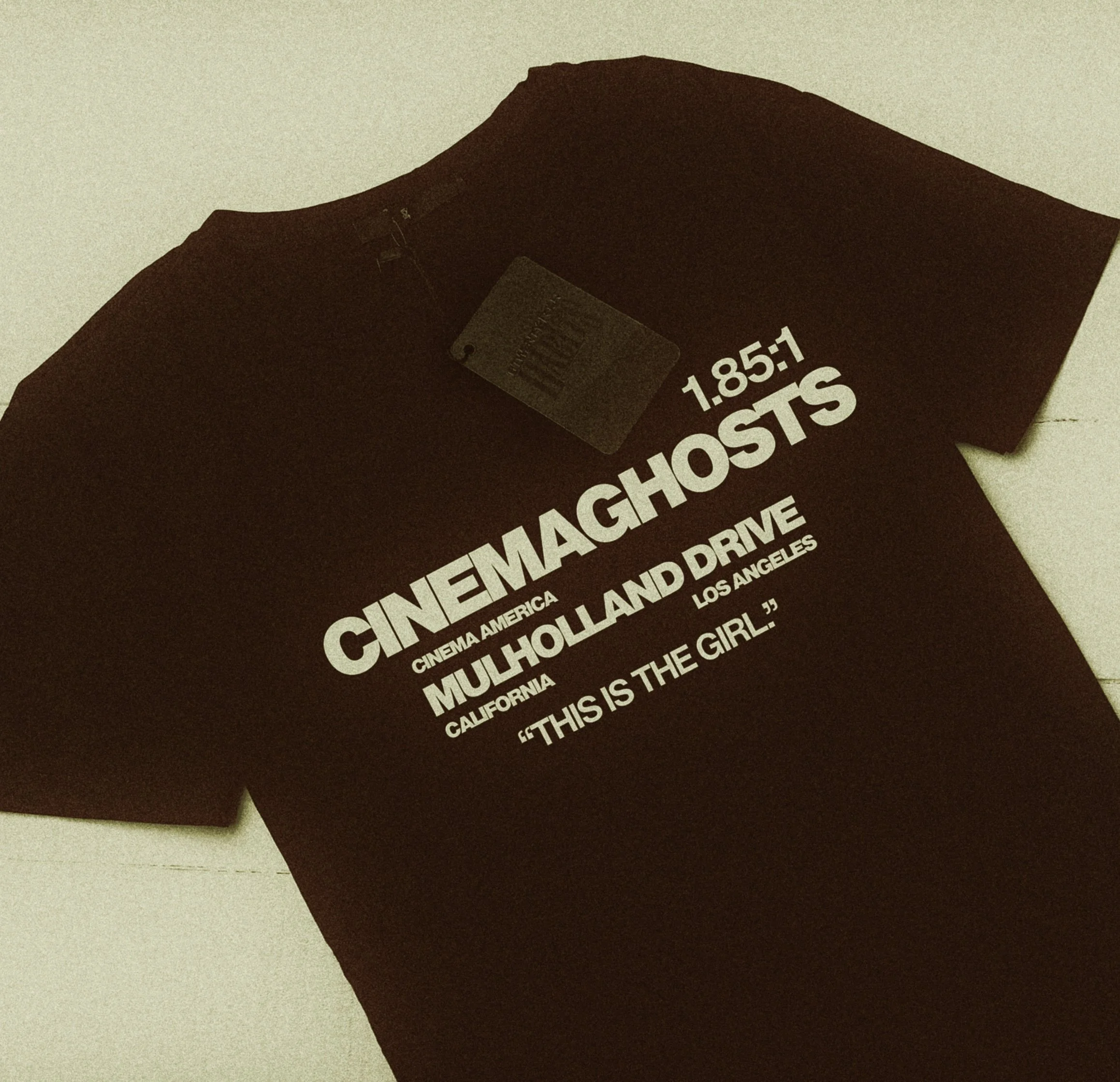 Black T-shirt with white text promoting 'Cinema Ghosts' screening at Mulholland Drive in Los Angeles, with the quote 'This is the girl.'