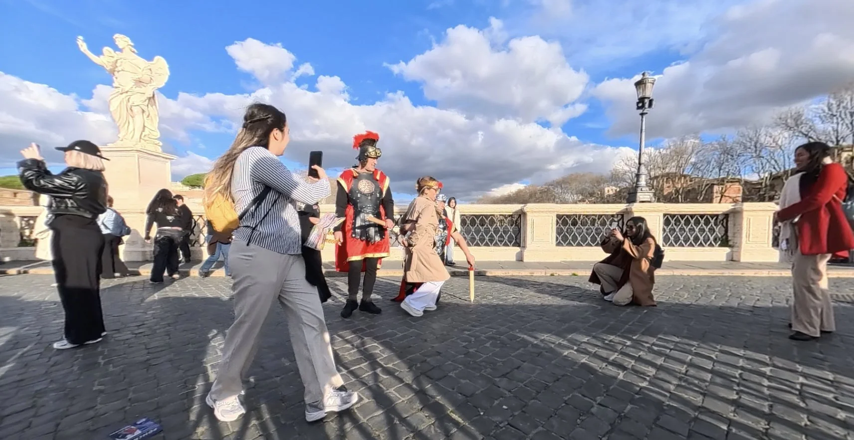Gladiator costume performers posing with tourists on Ponte Sant Angelo