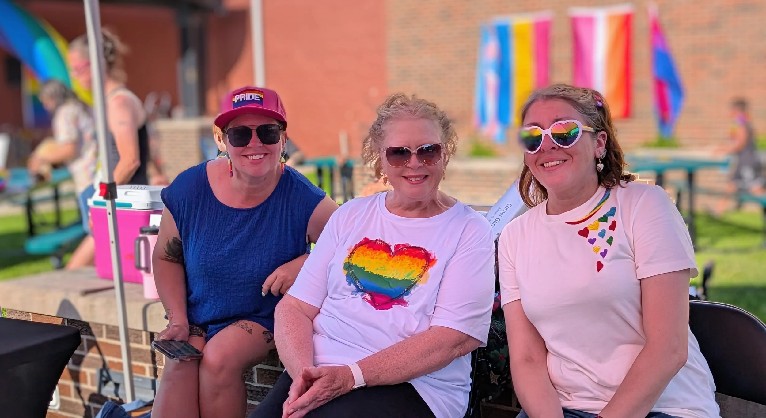 two people sitting at a information booth