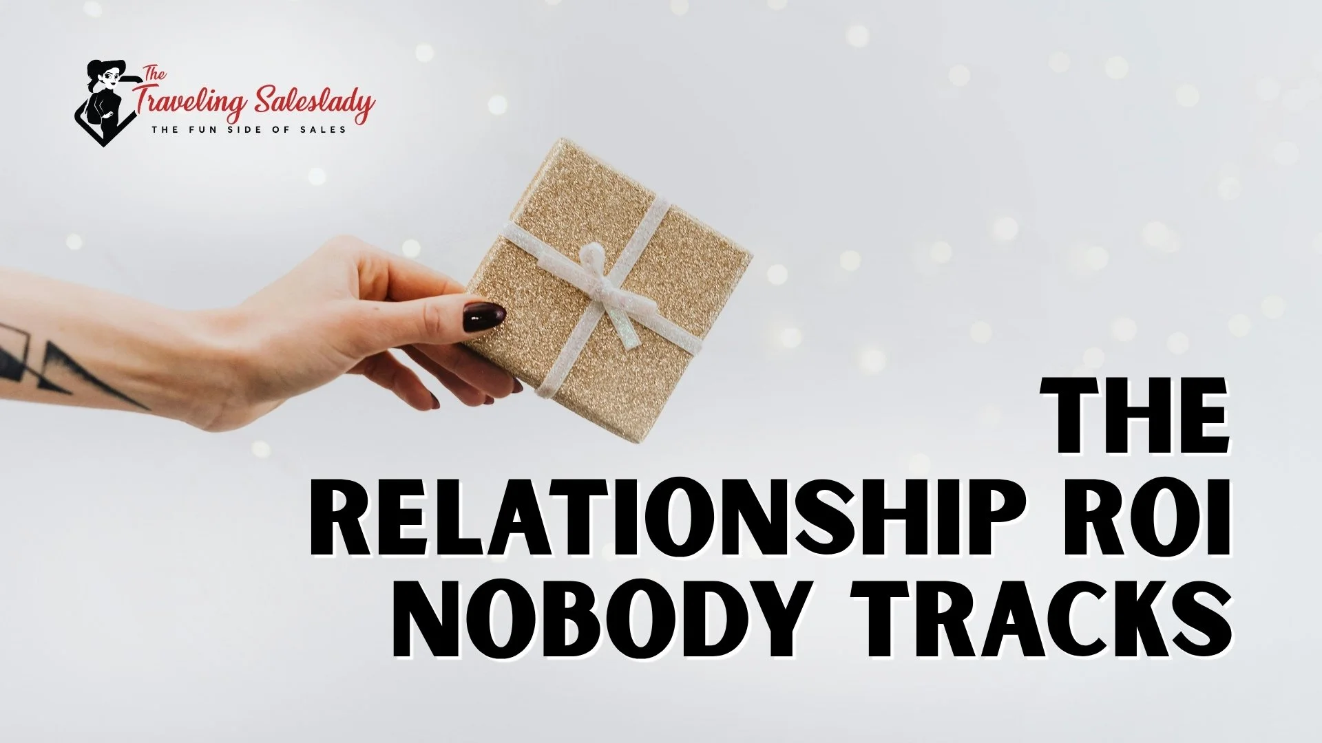 Person holding a small gift The Traveling Saleslady logo