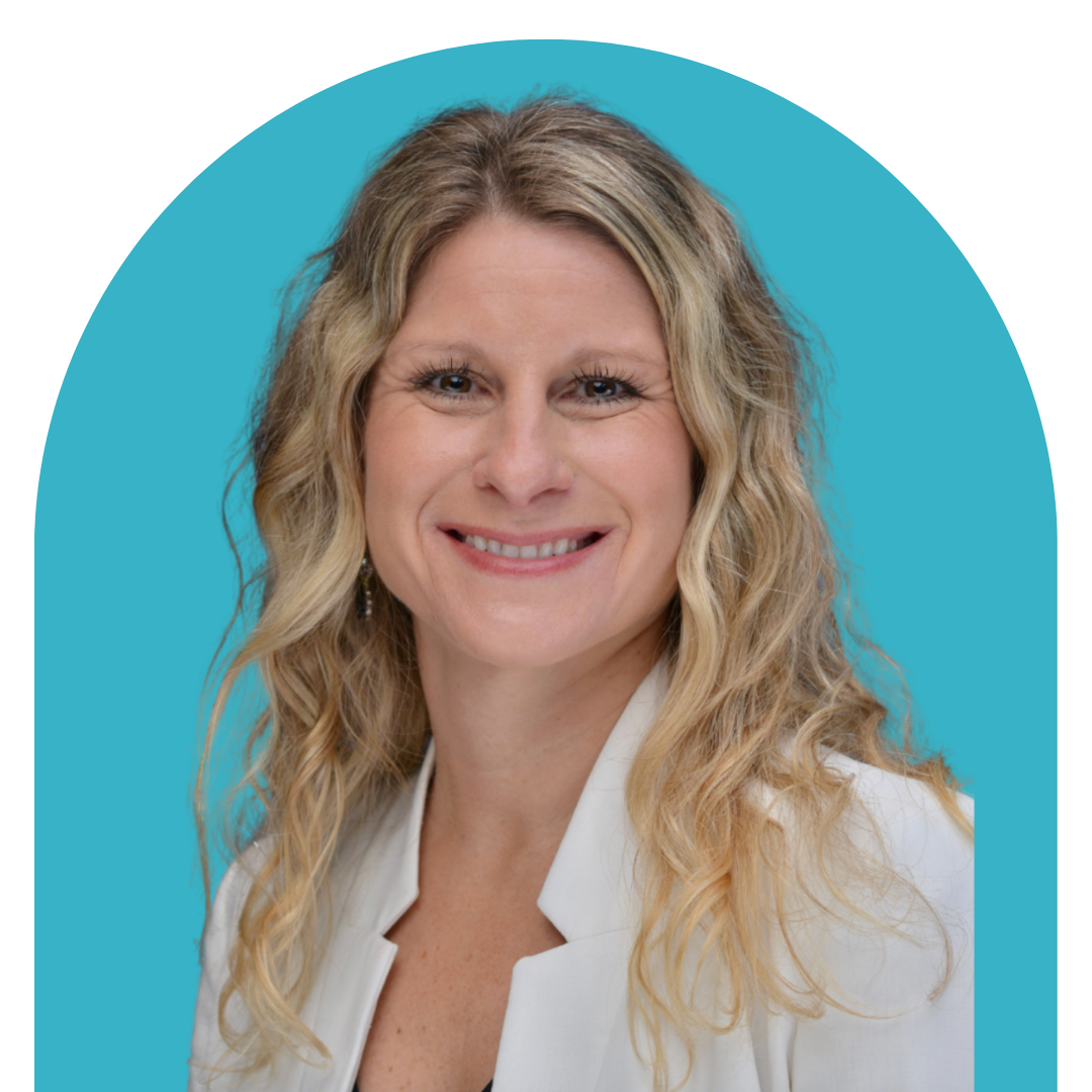Smiling woman with wavy blonde hair wearing a white blazer against a blue background.