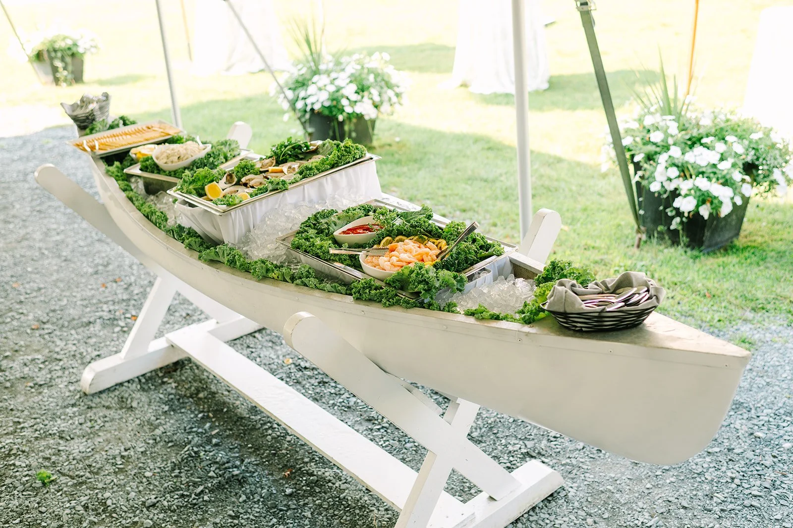 10' White canoe with custom built white wooden stand Photo by Juniper Studios