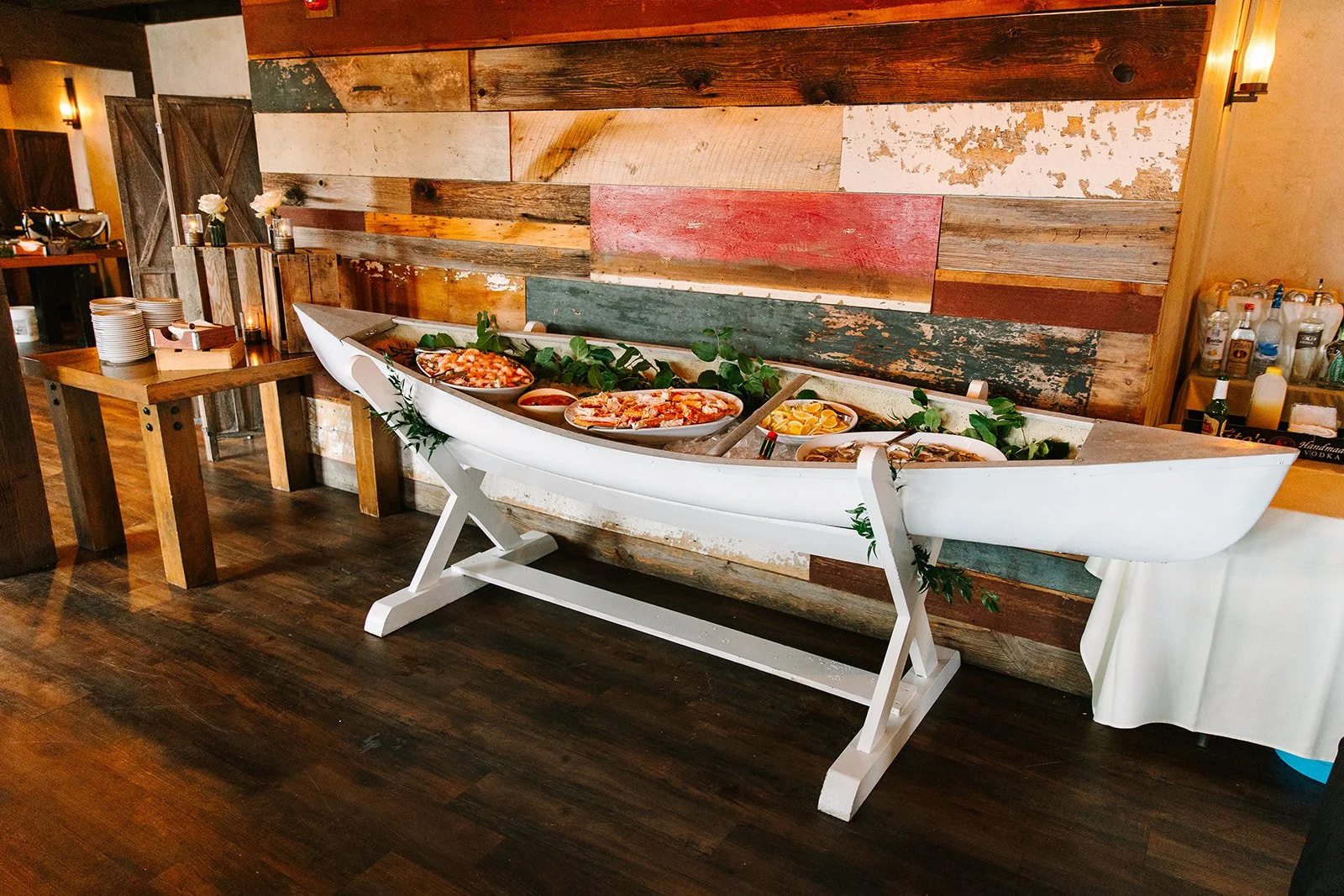 10' White canoe with custom built white wooden stand Photo by Juniper Studios