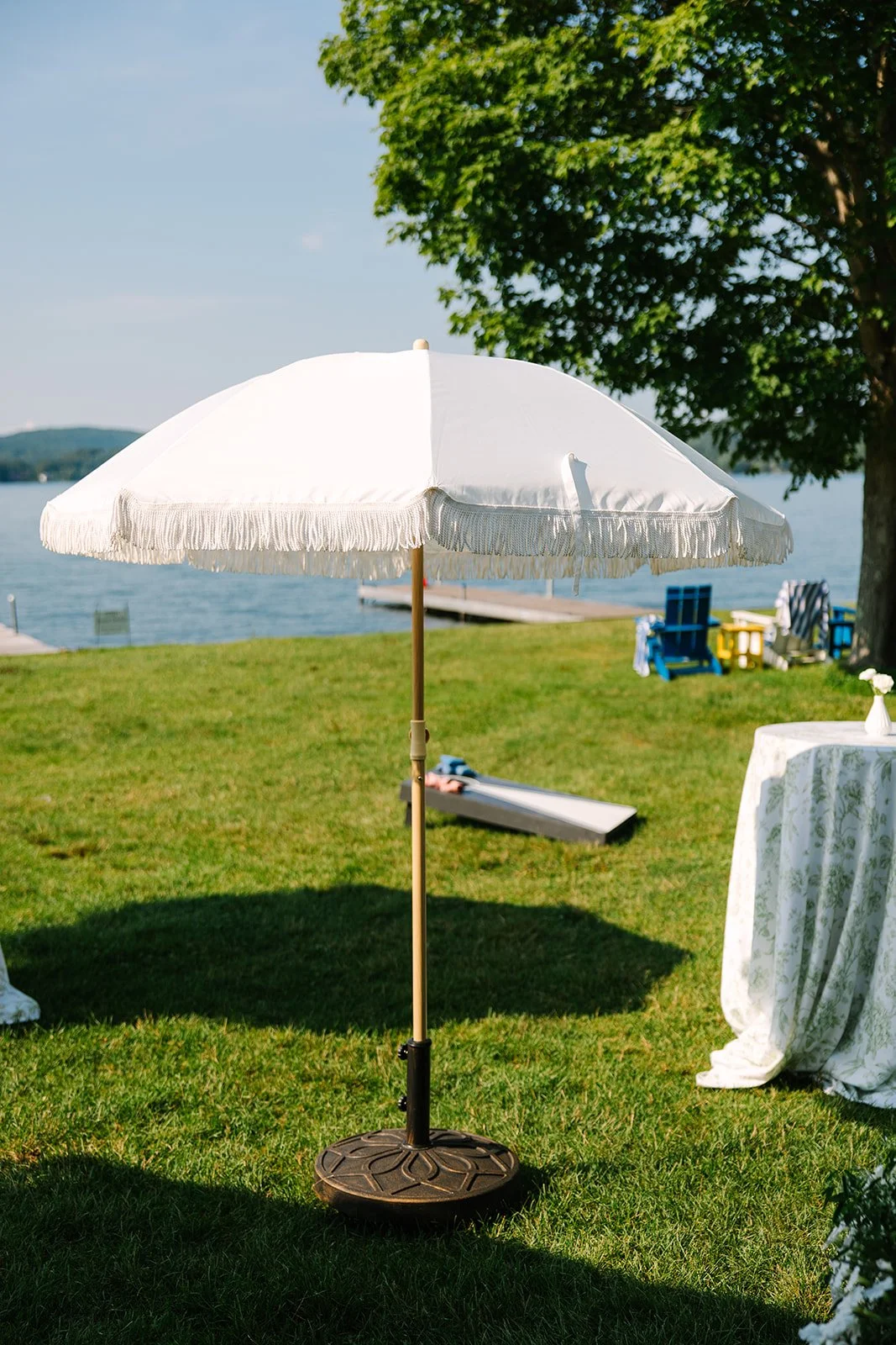 White fringe umbrella with base
Photo by Juniper Studios