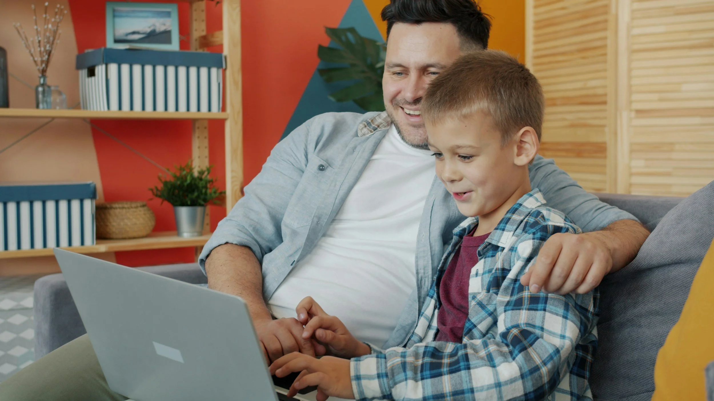 a father and son working on the computer