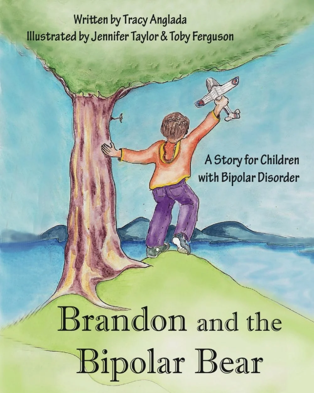 a child standing on a hill near a tree holding a model airplane