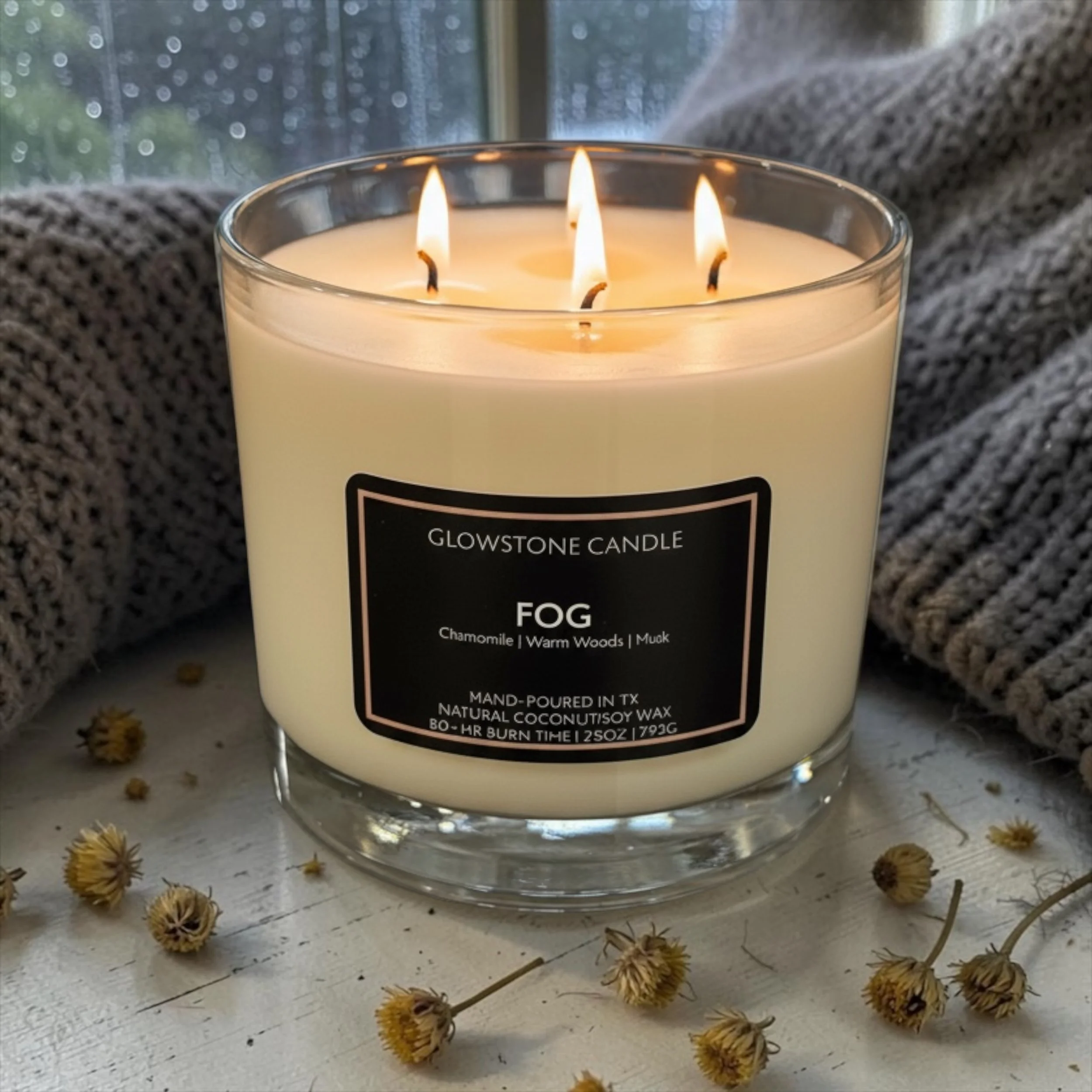 Our extra large, 4-wick candle with a burn time of 80-100 hrs in our signature Fog scent with notes of chamomile, warm woods and musk with a clear jar and black label.
