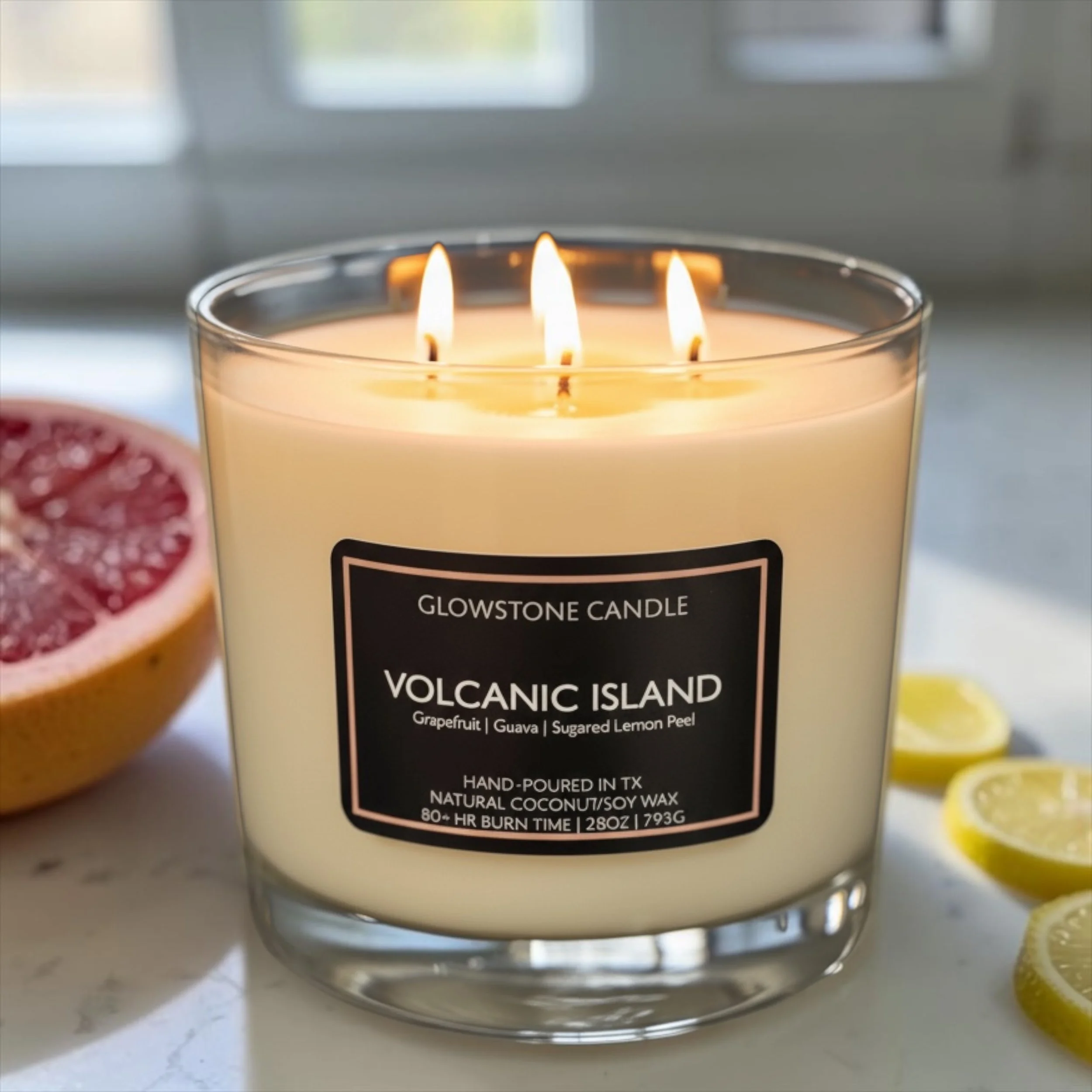 Our extra large, 4-wick candle with a burn time of 80-100 hrs in our Volcanic Island scent with notes of grapefruit, sugared lemon peel and guava with a clear jar and black label.