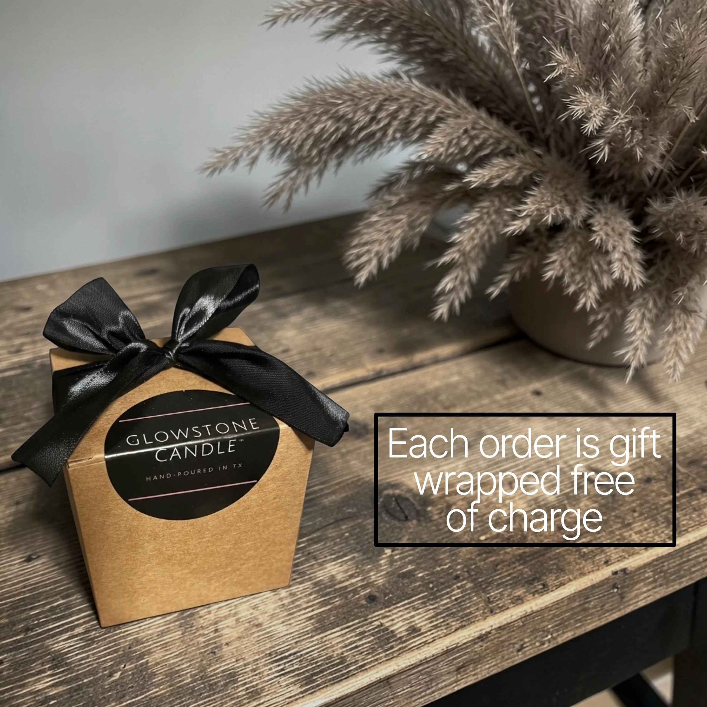 a photo showing our free gift wrapping with a brown Kraft box, black logo sticker and black bow