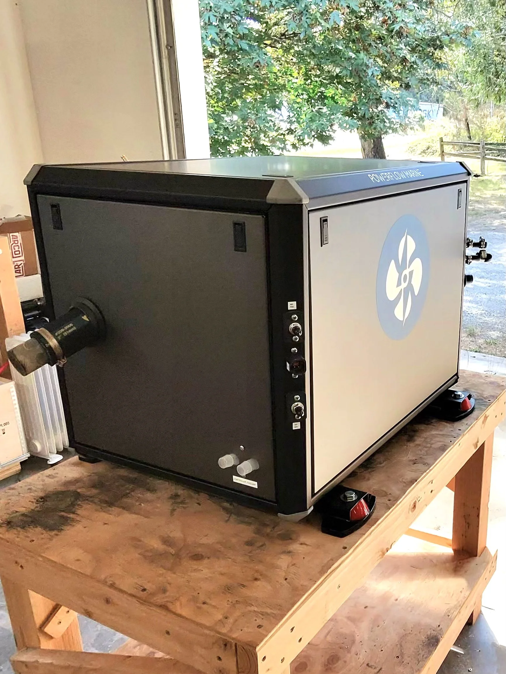Side view of the Powerflow Marine 48V DC generator showing exhaust outlet and compact enclosure footprint
