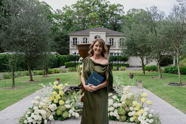 Melissa Price, Brisbane Marriage Celebrant and Master of Ceremonies, officiating an outdoor wedding ceremony at an elegant French provincial elopement venue on the Sunshine Coast, Queensland.