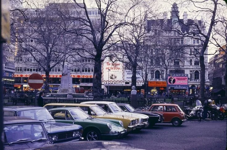 Historical image of Leicester Square theaters and crowds from the past, showcasing the area's vibrant history for office cleaning context.