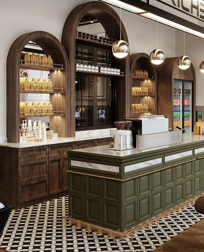 A coffee shop counter with a green and white marble top, wooden cabinets, and a dark wood arched shelving display. There are gold pendant lights hanging above, and coffee bags and supplies on the shelves.