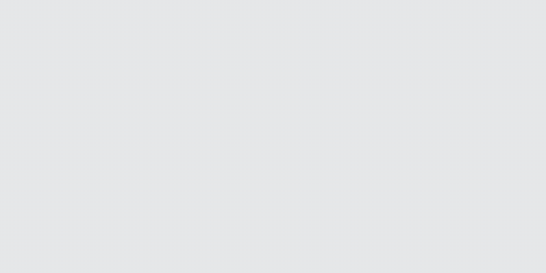A white background with a few tiny, dark-colored specks scattered across it.