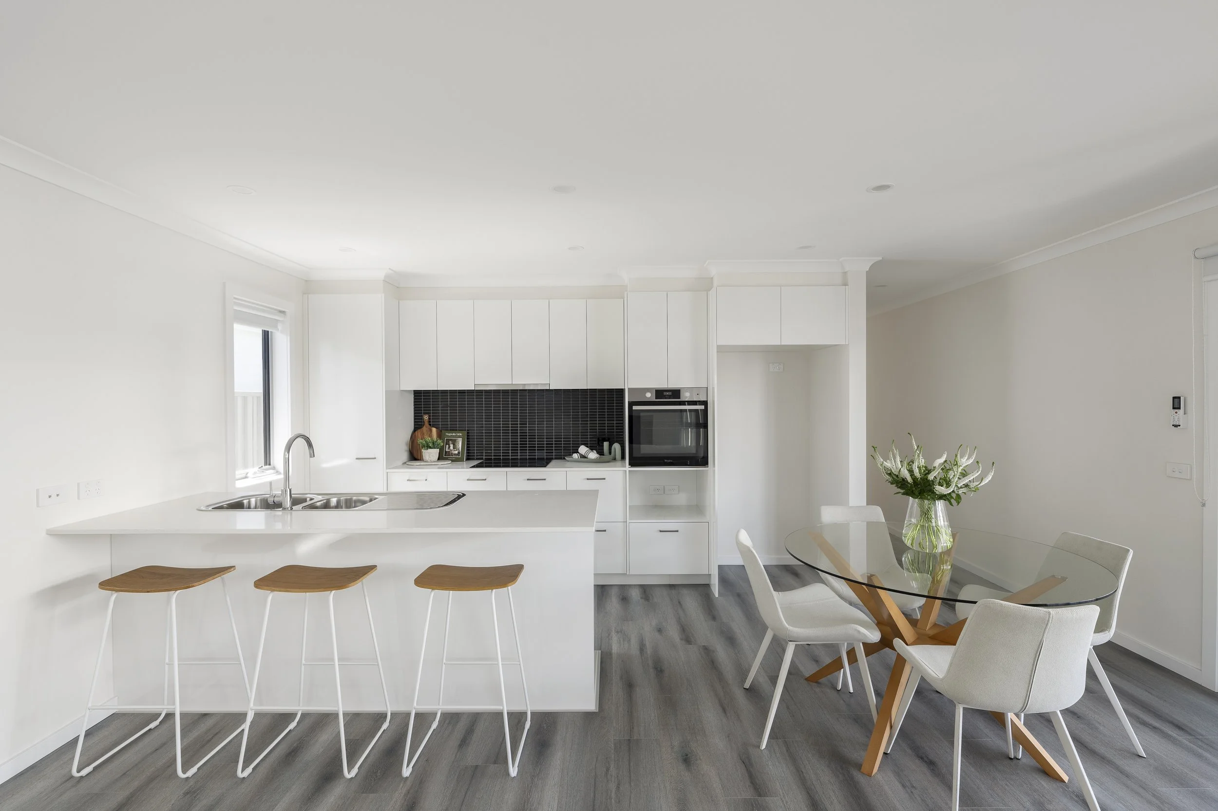 Modern kitchen with breakfast bar and dining space, designed for comfort and connection in downsizing.