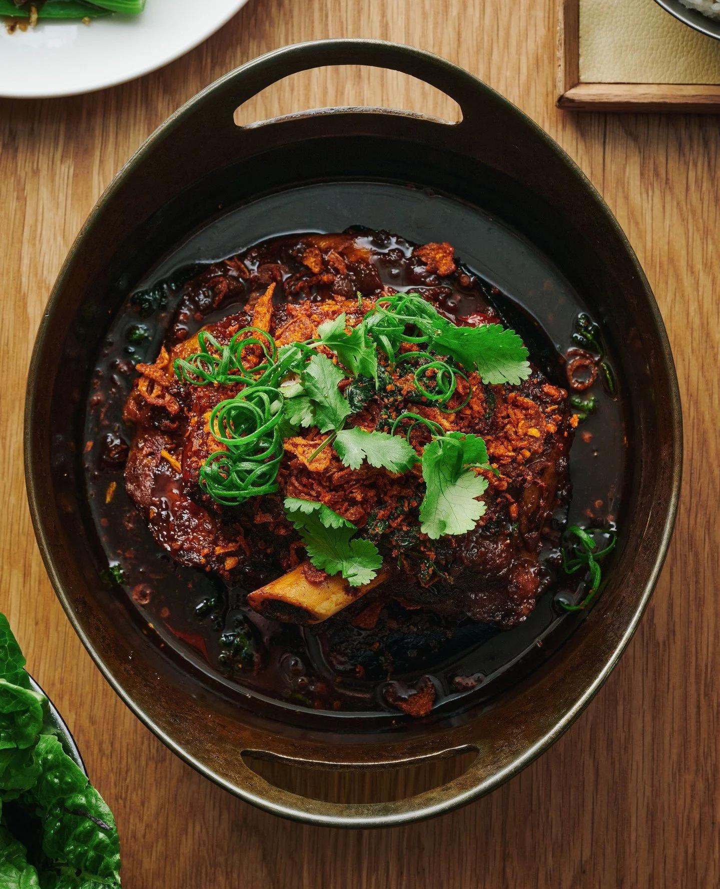 Slow-cooked lamb shoulder, coriander, Yuxiang sauce.⁠
⁠
Join us every day from 11.30am.
