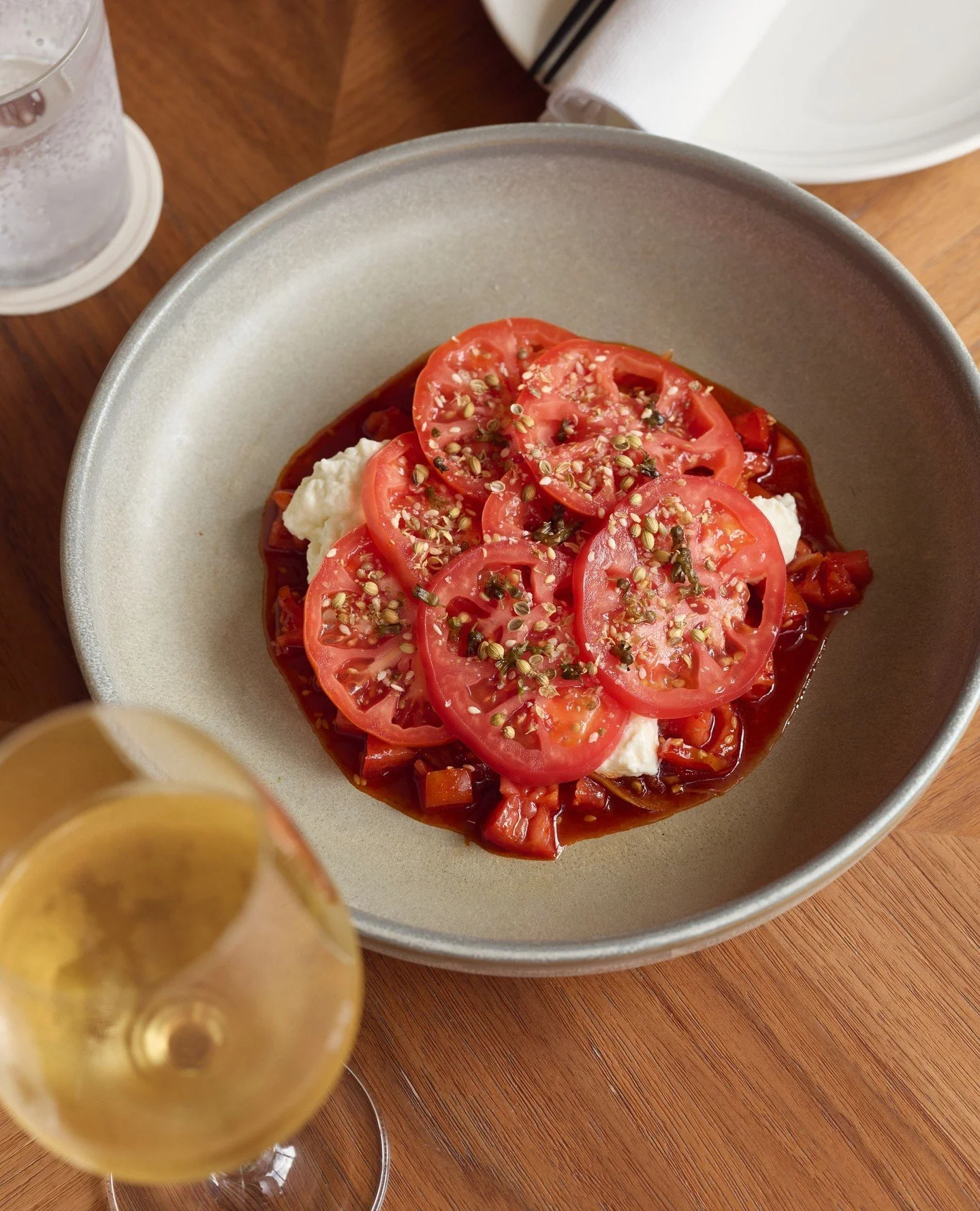 Heritage tomatoes, fermented chilli, sesame, stretched curds