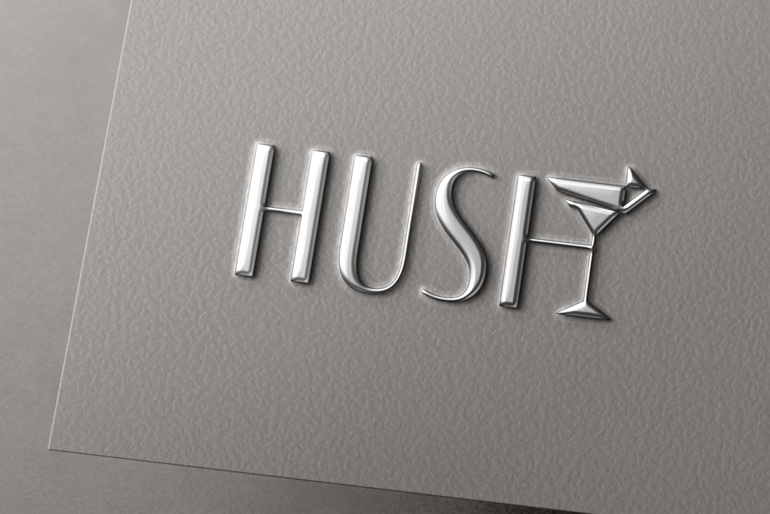 Silver three-dimensional letters spelling 'HIS' on a textured gray wall with a martini glass icon next to the letter 'S'.
