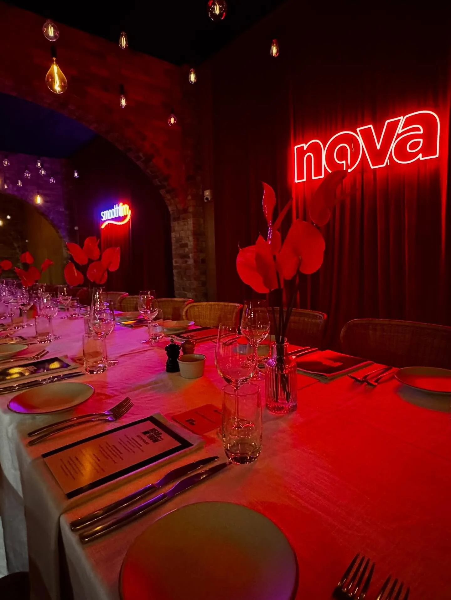 Red Anthurium orchids, neon lights and a whole lot of velvet transformed the space in a moody corporate event.