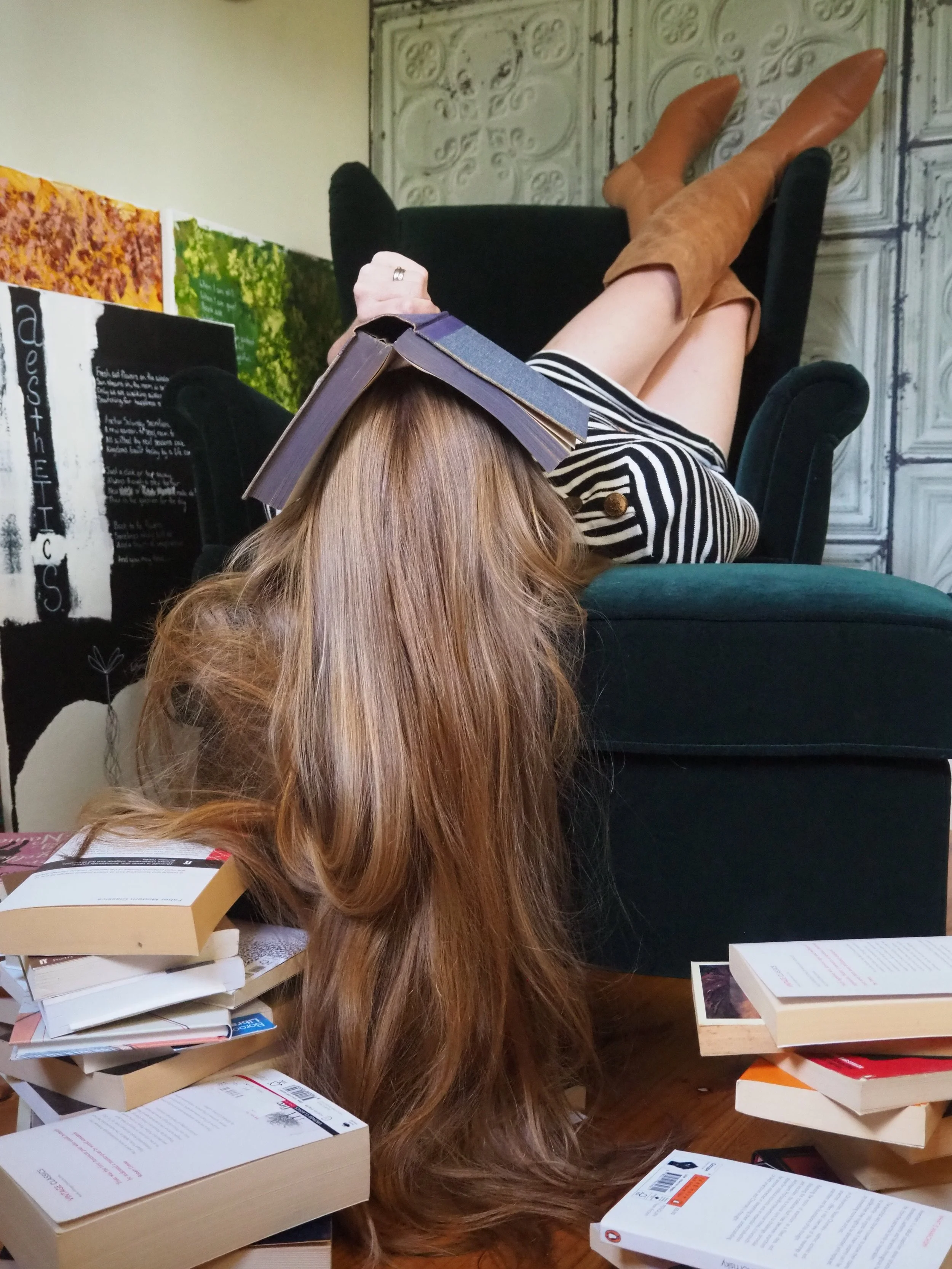An Image of Camille Delaquise on an armchair upside down