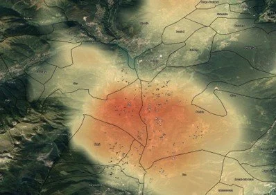 A topographic map of an area with color gradients from green to red, indicating varying elevation levels, with visible terrain features and boundary lines.