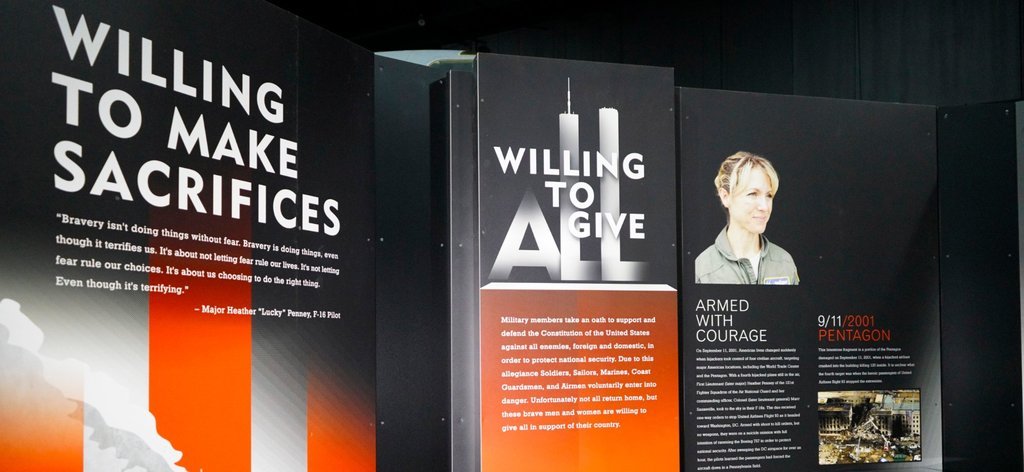 Black, orange, and white image of museum display about Heather Penney