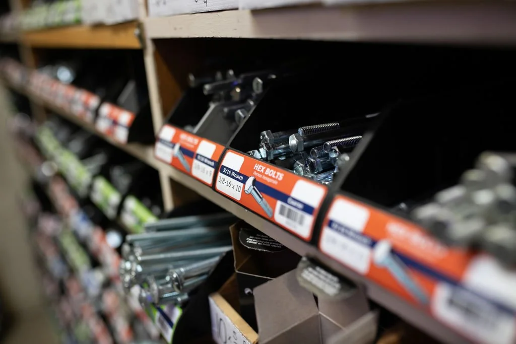 Close-up of hex bolt bins at Felton Hardware, showcasing a variety of sizes and grades of fasteners.