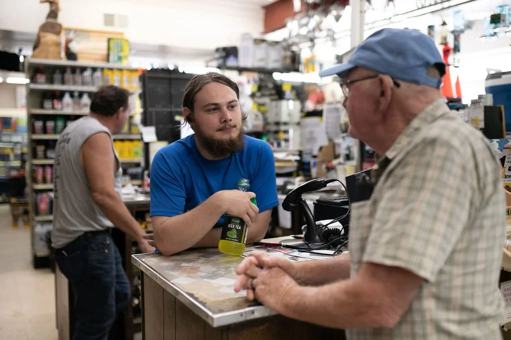 Wyatt Freeman standing at the counter at Felton Hardware, helping a customer