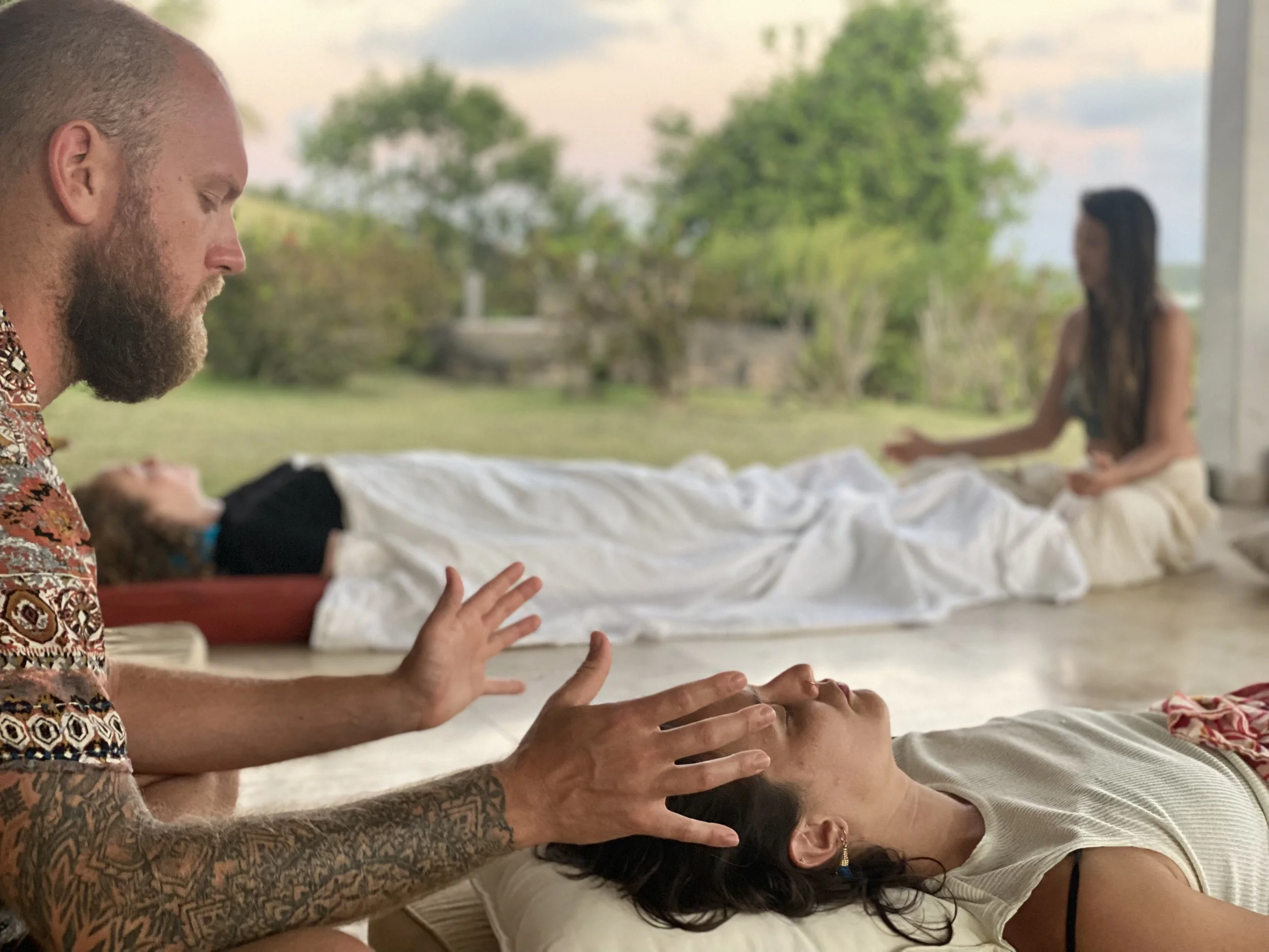 A person guiding a Breathwork session student practicum at the in-person retreat module for the breathwork facilitator training in Puerto Rico.