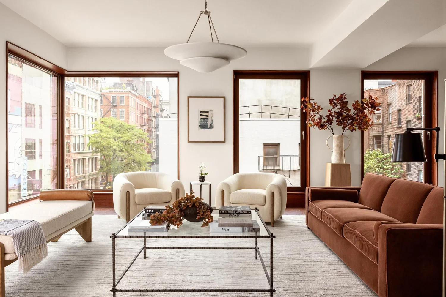 SoHo condo living room staging with curated furniture aligned to architectural wood tones in a new development residence.