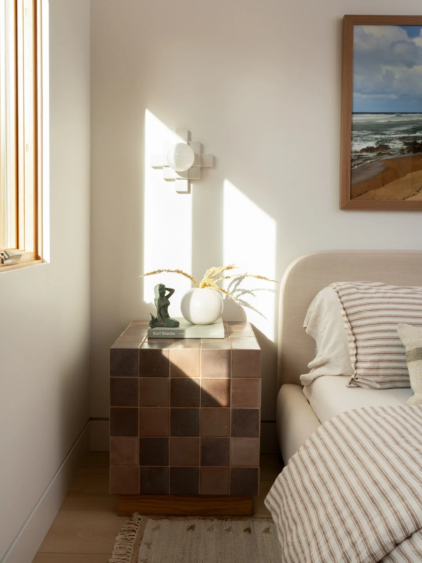 A custom tiled nightstand, funky sconces, a cute vintage mermaid, striped bedding, &amp; the best lighting in this guest room! 

_____________________________

Design: @californiarevivalstudio | Project: #CRSxCalifornia
Photography: @charlotteleaphot