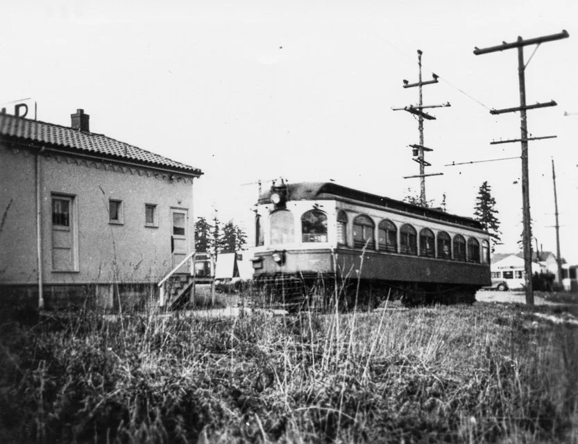 1939. Interurban trolley at Richmond Highlands station. Interurban trolley stopped at the Richmond Highlands station, behind the Richfield Gas Station at 185th Street North and Aurora Avenue. The Colegrove Restaurant is in the right background.