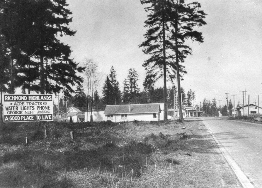 Billboard for Richmond Highlands Acre Tracts, looking north on North Trunk Road from about 183rd Street. At far left we see the back of Emma Griffin's rental house. Next to it with a half-hidden dormer is William and Hannah Dye's Home Bakery and Rest