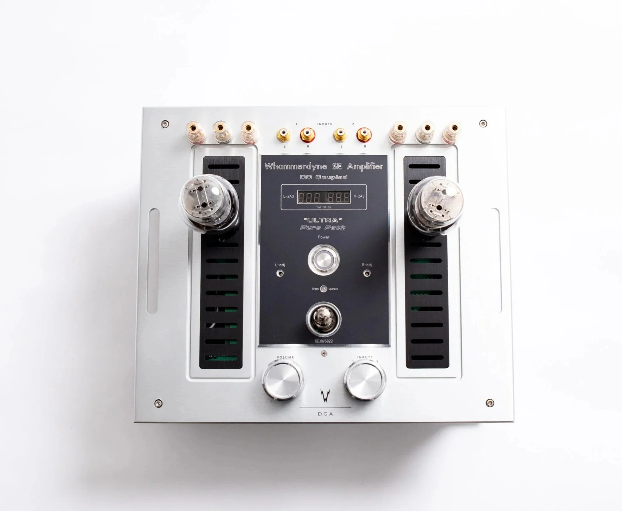 Whammerdyne DGA stereo amplifier shown from above, featuring brushed aluminum top plate, black accent panels, dual vacuum tubes, central control panel with green bias display, input tube, and volume and input selector knobs.