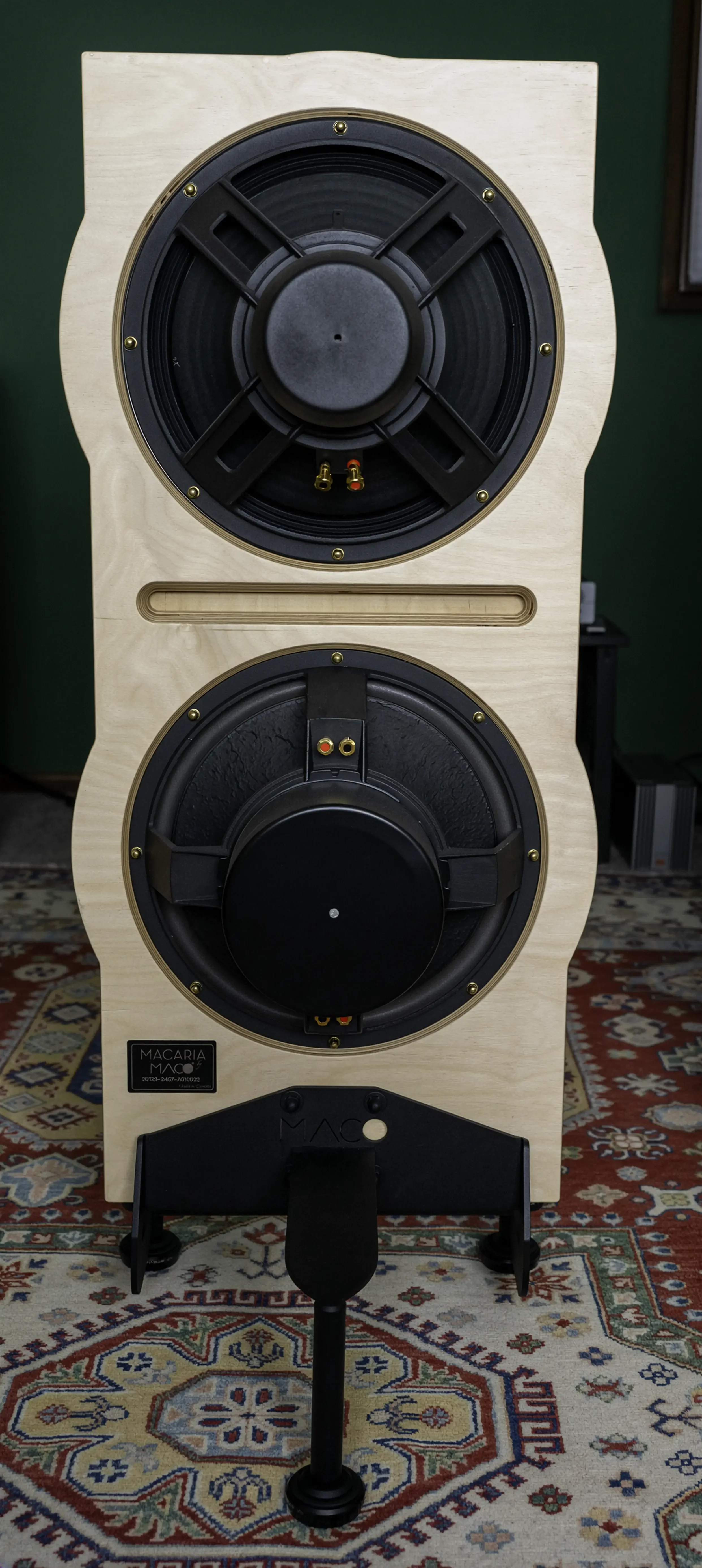 Rear view of a Maco Macarias loudspeaker showing the exposed driver assemblies, Baltic birch baffle, and floating base.